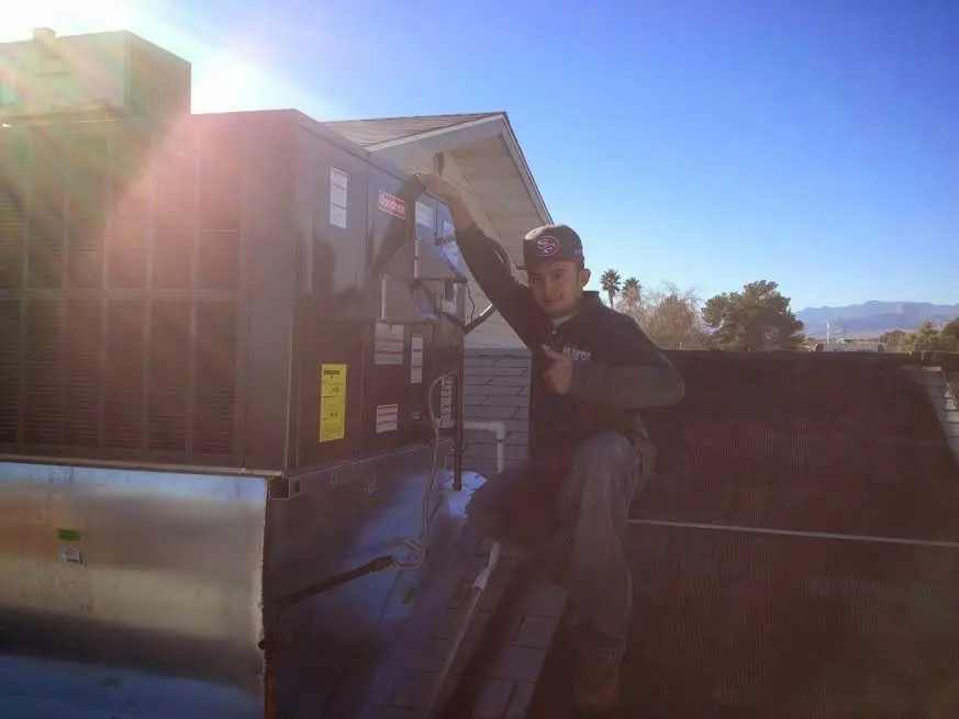 HVAC technician performing HVAC Inspection on a rooftop unit in South Hadley